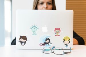 A laptop with various stickers on it, this is an example of where smaller sticker sizes are needed