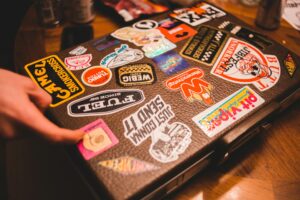 a laptop with a variety of stickers on it