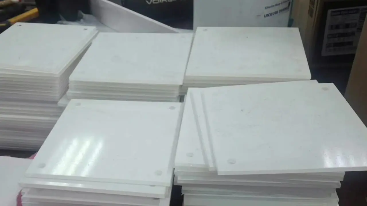 Stacks of blank Perspex photo blocks prepared for a custom corporate wall display