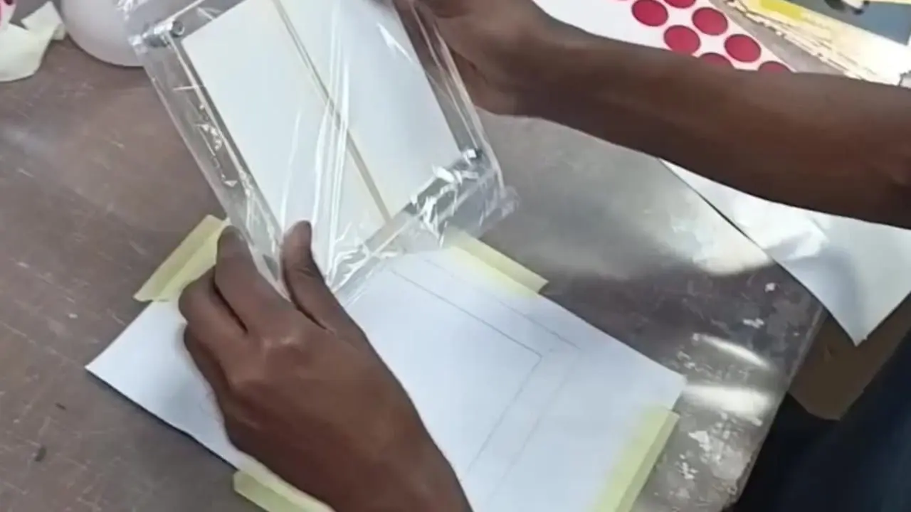 Redblock employee completing the finishing stage on a Perspex display block