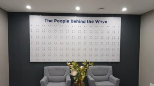 Custom ACM corporate display board with 360 standoffs installed on an office wall