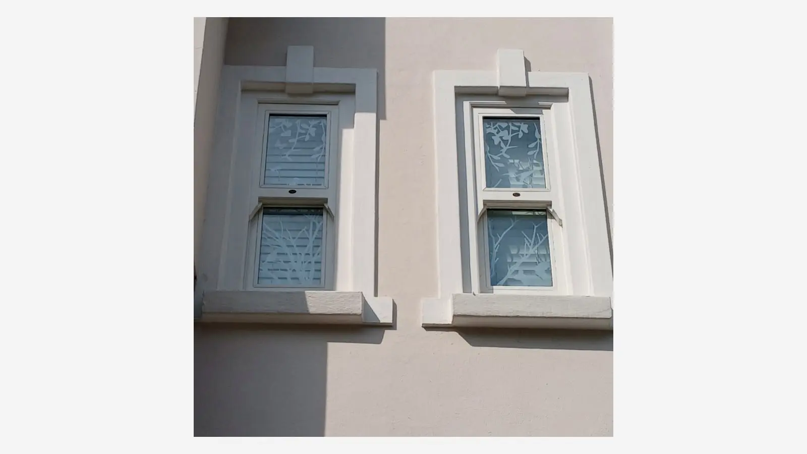 Two narrow windows with coordinated frosted vinyl branch patterns