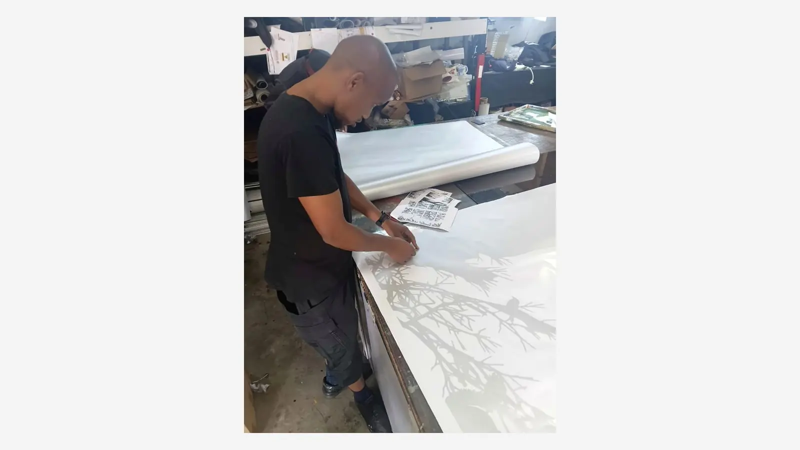 Redblock team member preparing a detailed frosted vinyl pattern in the workshop