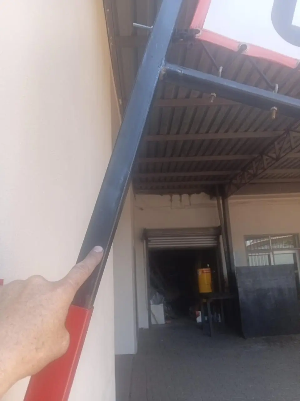 Round steel arm on a custom wall-mounted projecting banner frame