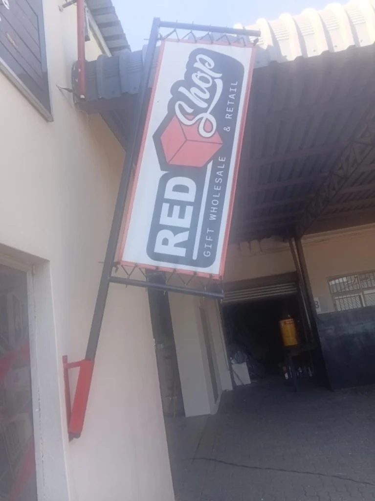 Custom wall-mounted projecting banner frame with a fitted business banner