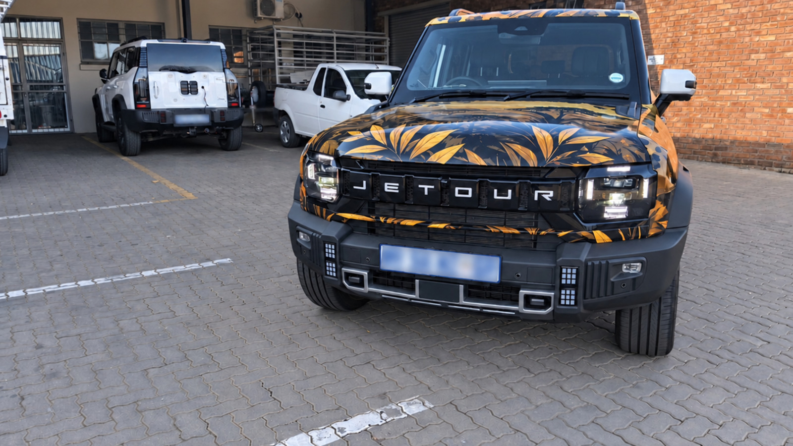 Completed safari-inspired Jetour T2 full vehicle wrap from the front with registration plate blurred